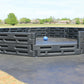 Outdoor gaga ball pit made of modular black plastic panels with a blue ball on a rubber play surface by Castle Sports.